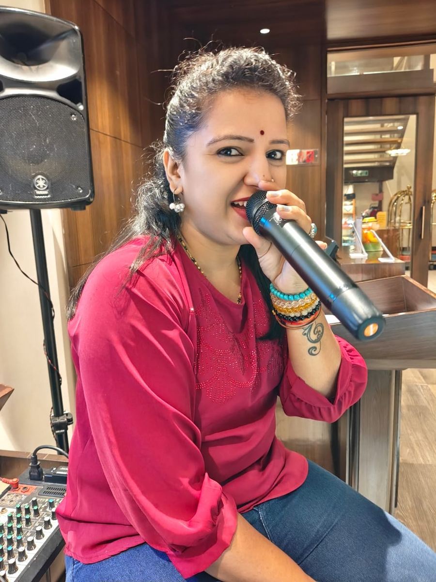 Priya singing in event setting